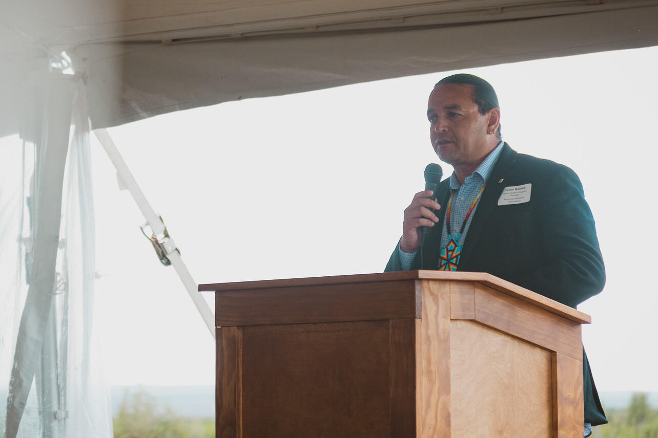 A man speaks at a podium.