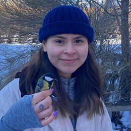 Photo of Esmeralda Villon holding a bird.