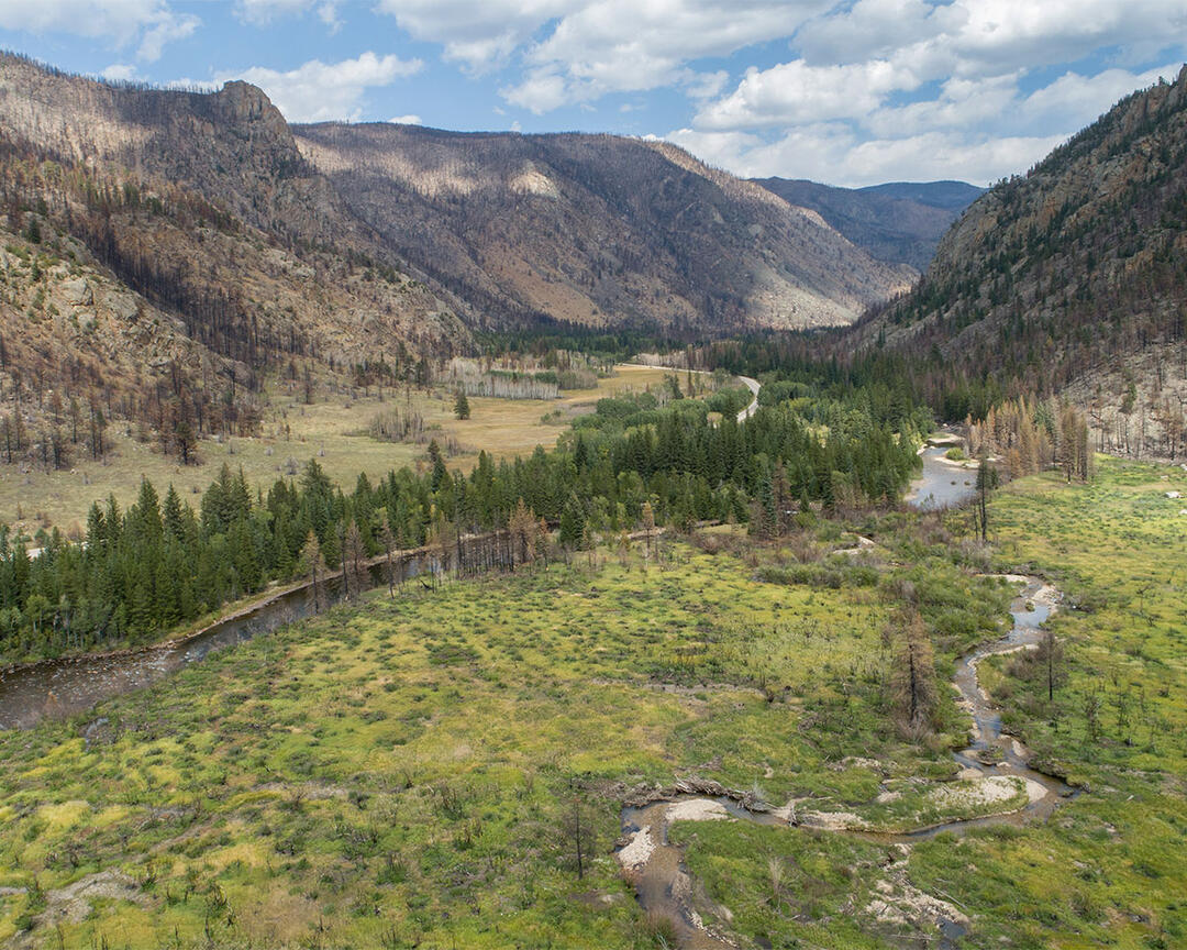 A river runs through a mountain valley.